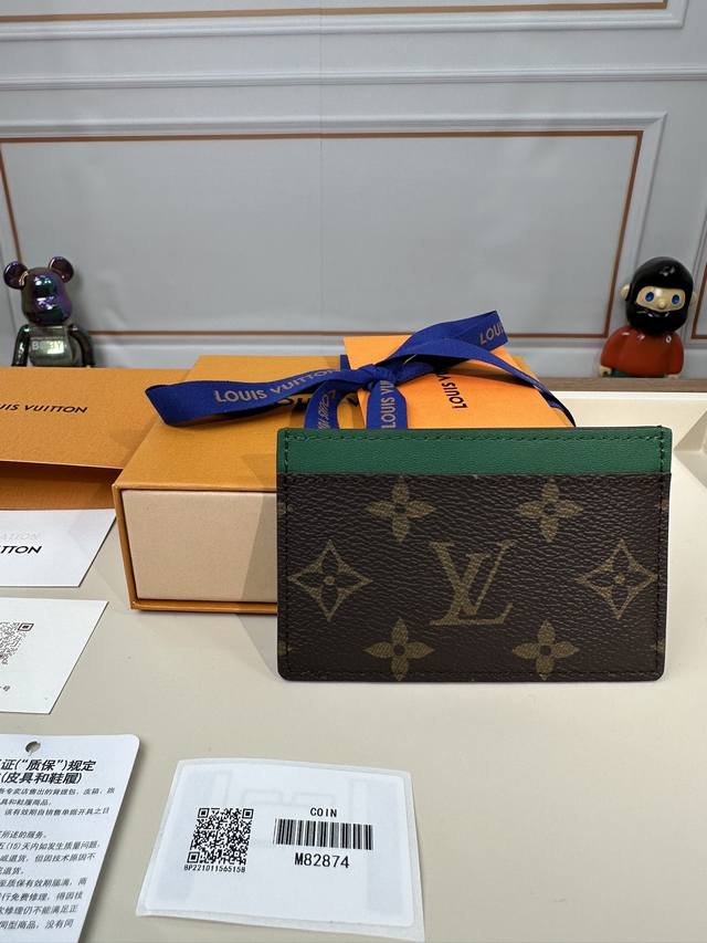 M82874【特级正品】本款小号卡夹取材monogram Macassar涂层帆布，为顶部牛皮革饰边和考究内衬同步渲染明亮色调。内部空间可容纳大号卡片和票据，外